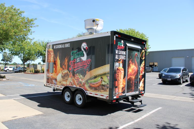 Rear angle of 16ft Mexican food trailer with flame graphics and rooftop ventilation for Tacos El Flamingo