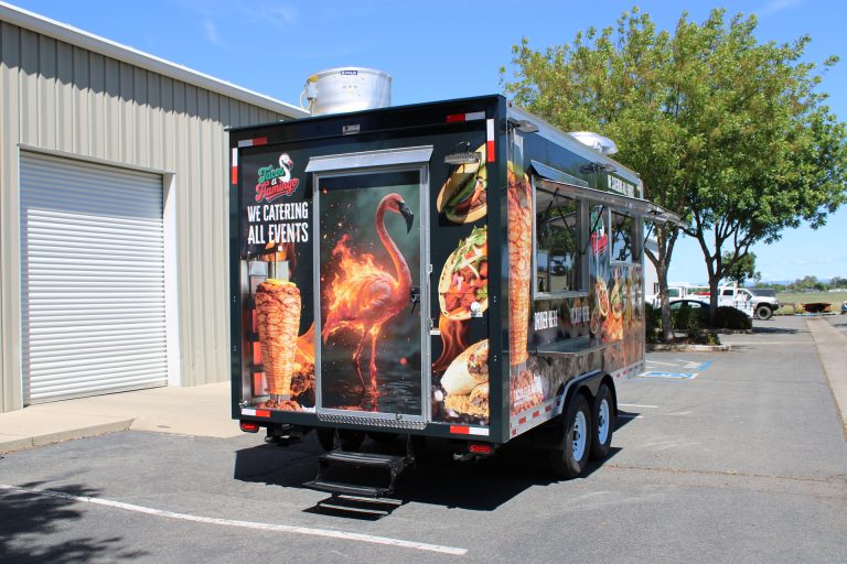 Rear entrance of 16ft Mexican food trailer with flamingo graphics and catering branding