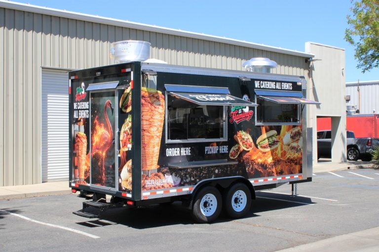 Side view of 16ft Mexican street food trailer with serving window and flame-themed graphics
