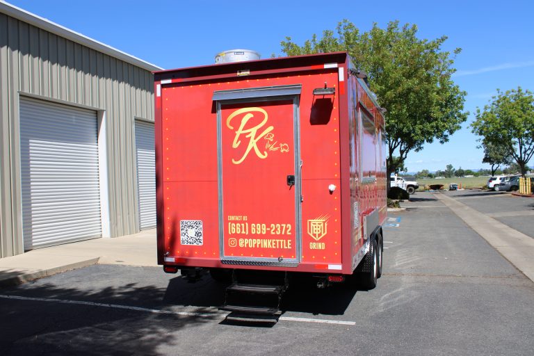 Rear entrance of 18ft kettle corn trailer with red custom wrap and aluminum exterior details