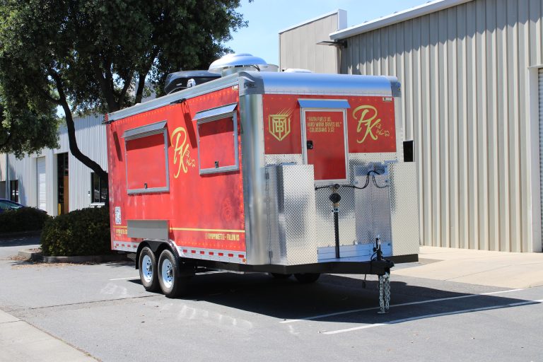 Front side angle of 18ft kettle corn trailer with polished aluminum storage and red custom wrap