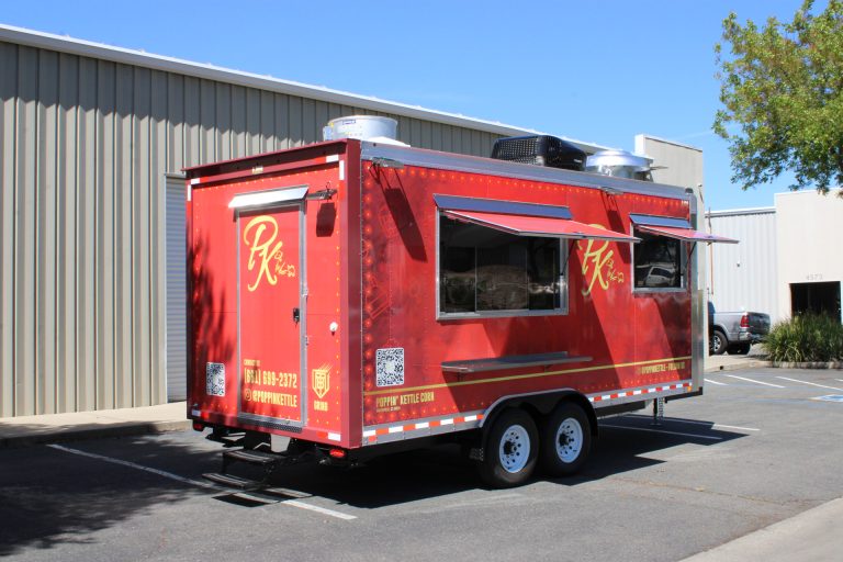 18ft kettle corn trailer with serving window, red custom wrap, and tandem axle setup in California