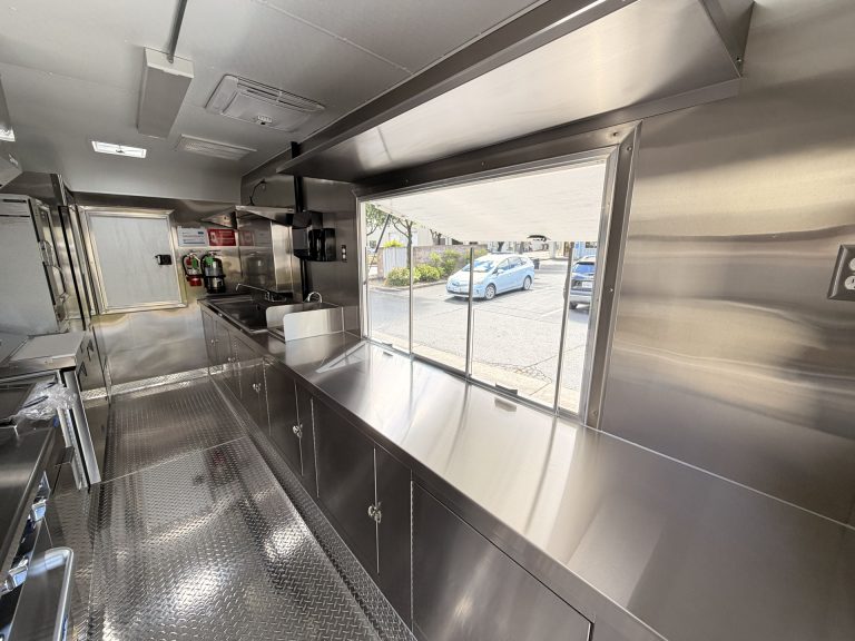 Food trailer service window with welded 304 stainless steel counter and cabinet storage interior view San Jose CA