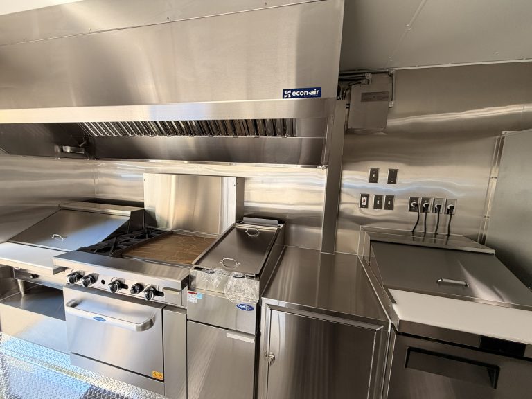 Food trailer commercial griddle fryer and NSF certified equipment under stainless steel hood system Golden State Trailers build