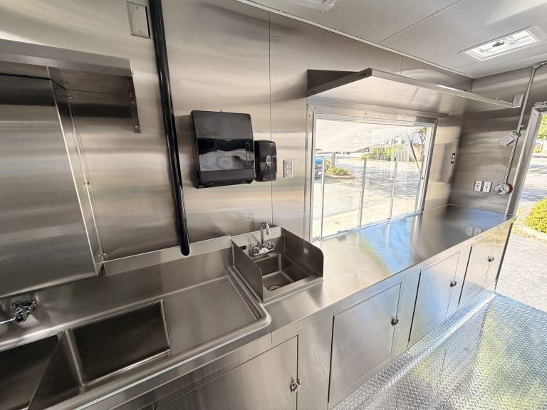 Food trailer handwash sink stainless steel shelving service window side detail and under-counter storage Golden State Trailers San Jose