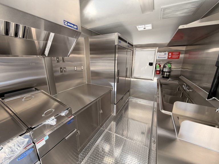 Shorter's BBQ and Catering food trailer interior with commercial reach-in refrigerator, steam table, fire suppression system and welded stainless steel cabinets
