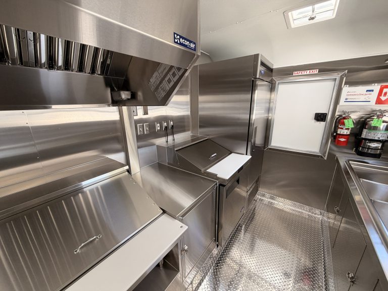 Interior kitchen layout with commercial refrigeration and cooking equipment inside 16ft Mexican food trailer