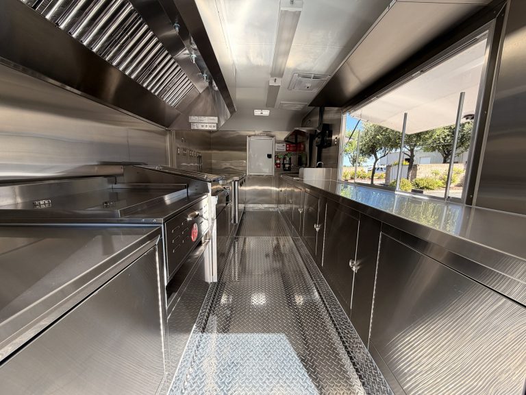 Interior aisle of 18ft kettle corn trailer with stainless steel kitchen and aluminum flooring