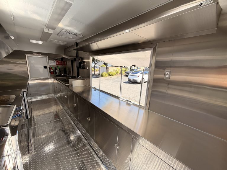 Interior concession counter with large serving window inside 18ft kettle corn trailer