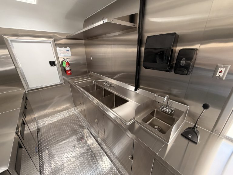 Stainless steel sink and sanitation area inside 18ft American food trailer kitchen