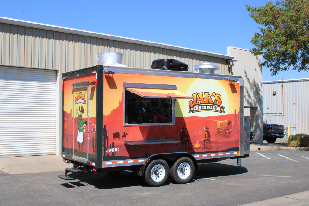 Custom concession trailer with Western desert wrap for Jak’s Chuckwagon, side serving window and rooftop AC