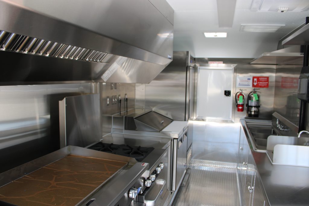 food trailer kitchen with commercial cooking equipment and stainless steel countertops