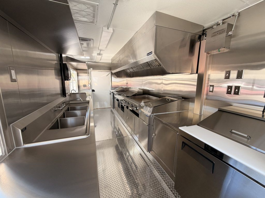 Custom food trailer interior with stainless steel prep counters and serving area