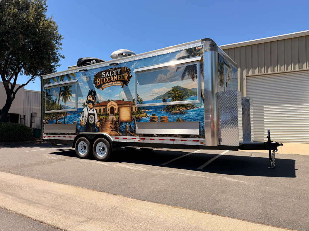 Custom food trailer with scenic blue exterior wrap and stainless steel front