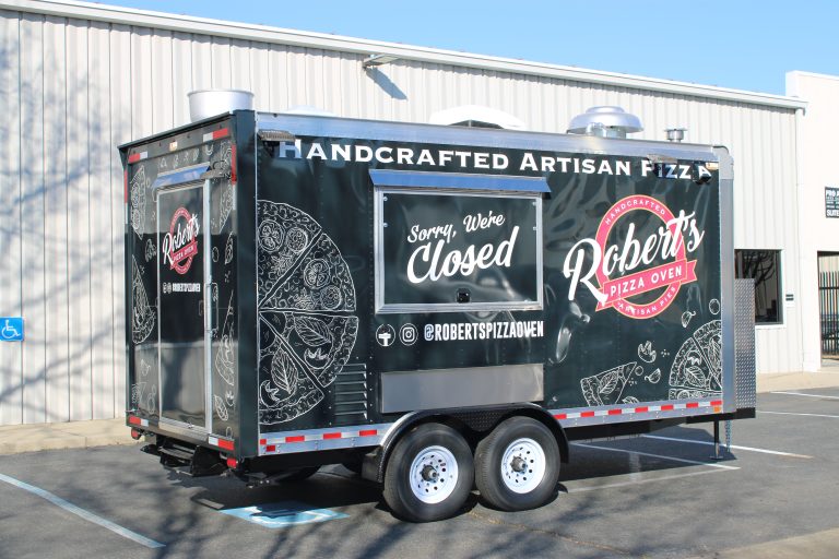 Rear passenger side angle of 16ft pizza food trailer with artisan graphics in Hills California