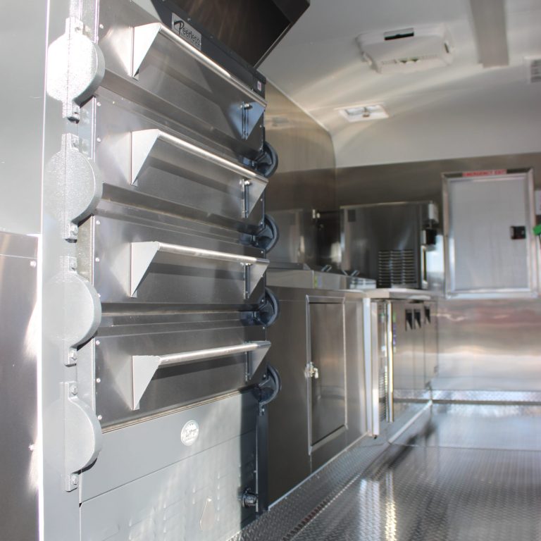 Stacked commercial pizza ovens inside 16ft pizza food trailer kitchen in Hills California
