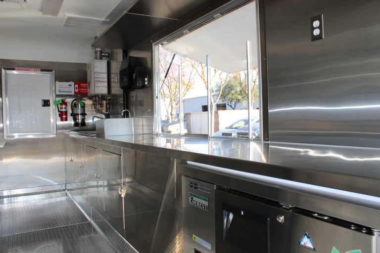 Interior stainless steel service counter inside 16ft pizza food trailer kitchen in Hills California