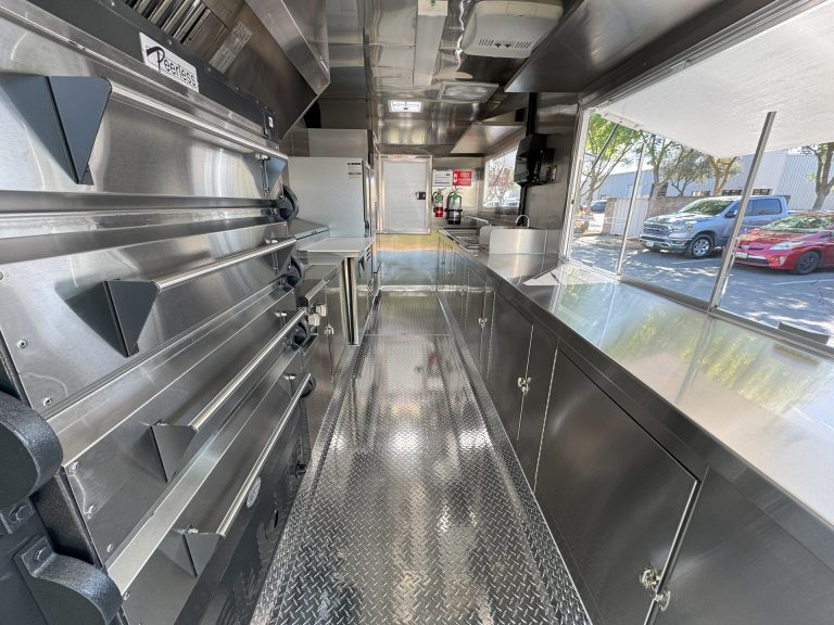 Interior pizza kitchen inside 16ft golf course food trailer with stainless steel counters and ovens