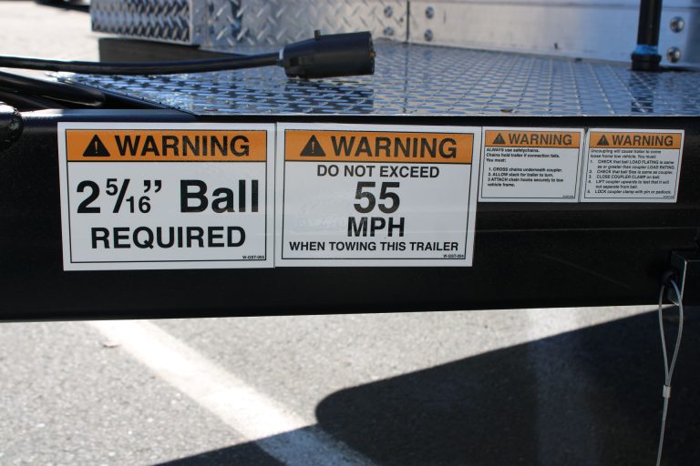food trailer hitch system with safety labels and towing requirements detail