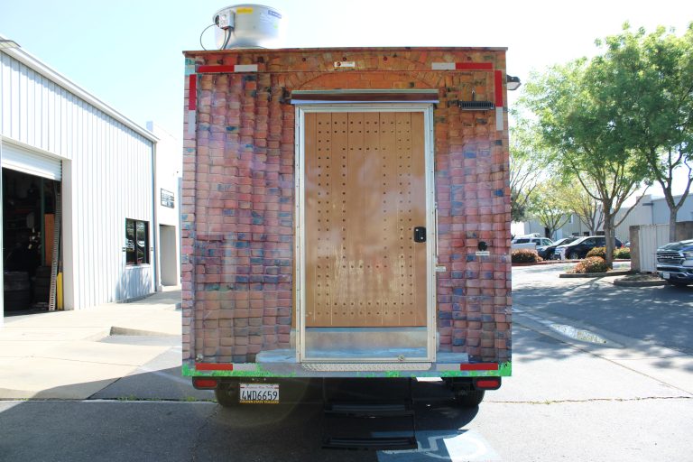 Rear exterior of 16ft golf course food trailer with custom stone texture wrap in Browns Valley California