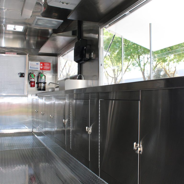 Interior stainless steel service counter inside 16ft golf course food trailer kitchen