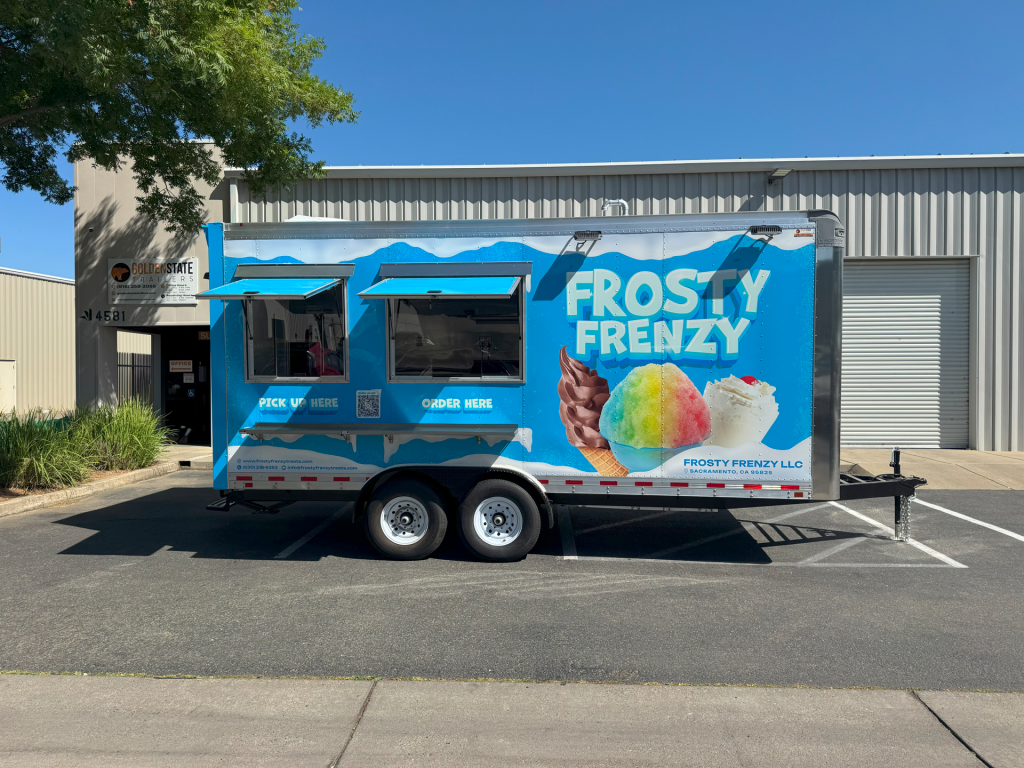 Frosty Frenzy food trailer with soft-serve and shaved ice graphics, a dessert and ice cream food truck concept.