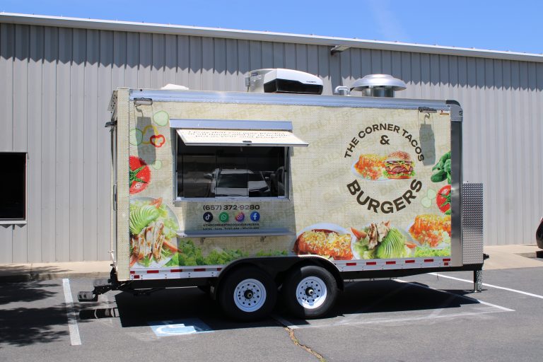 The Corner Tacos & Burgers food trailer in a cream food-photo wrap with an open serving window