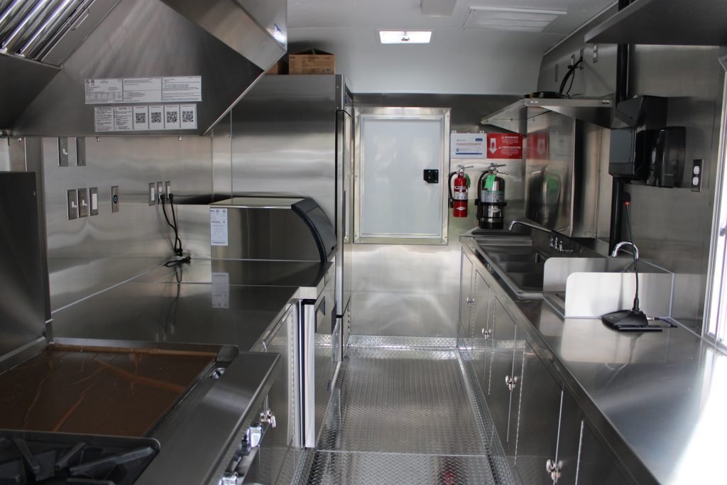 Compact commercial kitchen inside a custom coffee trailer.