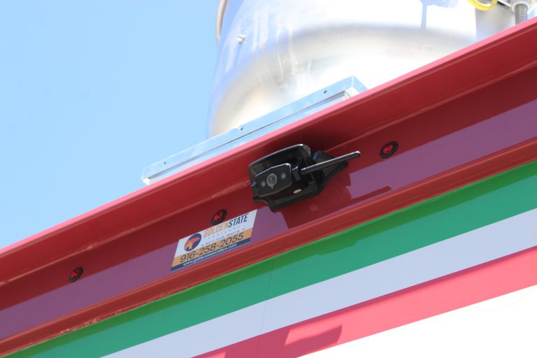 exterior security camera mounted near roofline of pizza food trailer