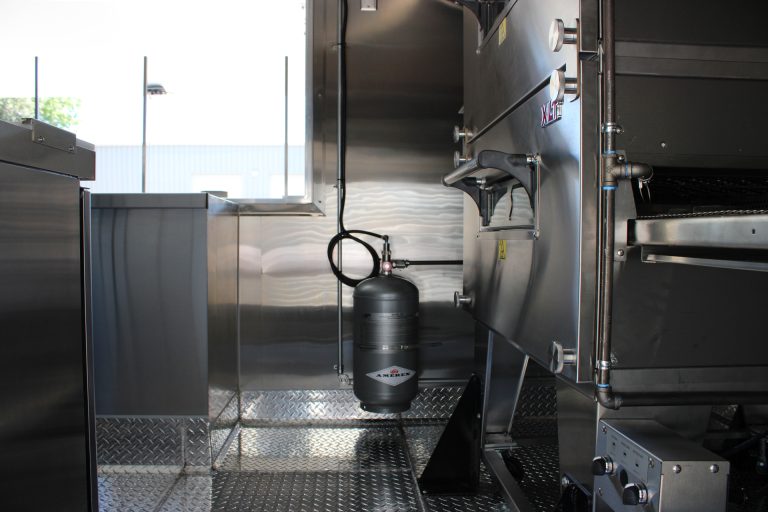 utility system components inside commercial pizza food trailer