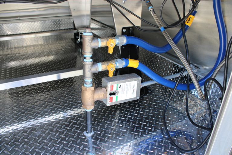water and plumbing connections inside pizza food trailer