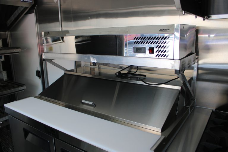 stainless steel prep workstation inside commercial pizza food trailer
