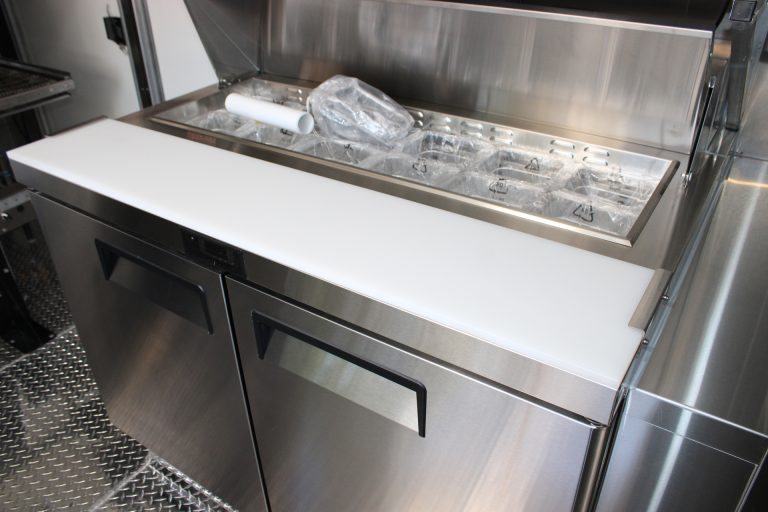 refrigerated prep station inside commercial pizza food trailer
