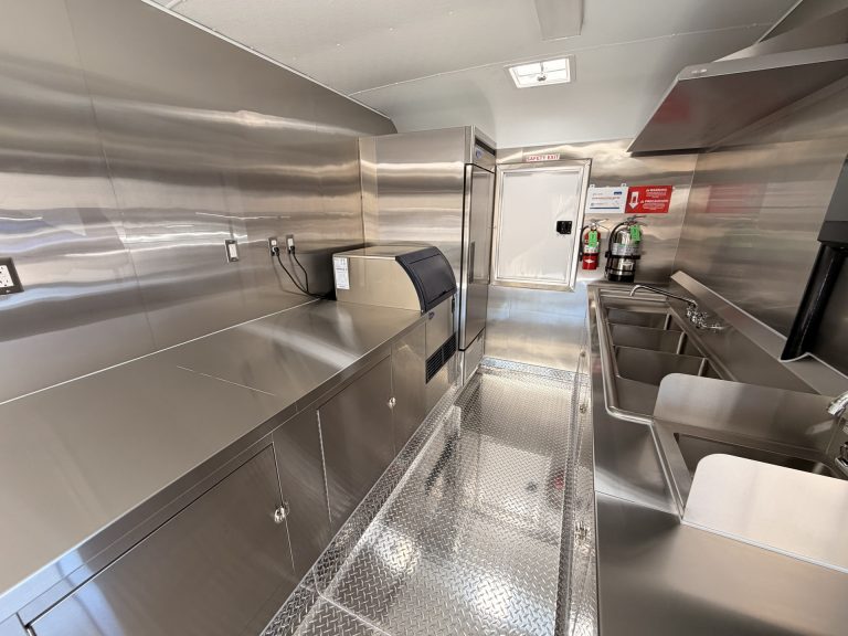 Wide interior view showing the organized preparation, refrigeration, and sanitation workspace.