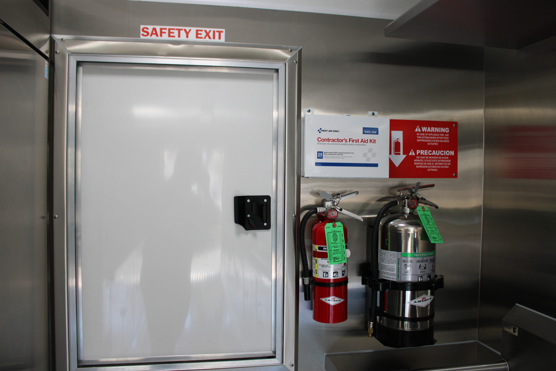 Safety exit and fire extinguishers inside the Avenal High School school food trailer