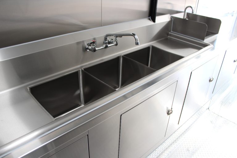 Three-compartment stainless steel sink inside the Avenal High School school food trailer