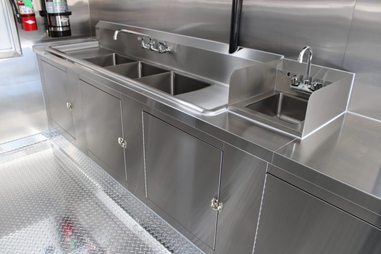 Three-compartment sink workstation inside the Avenal High School school food trailer
