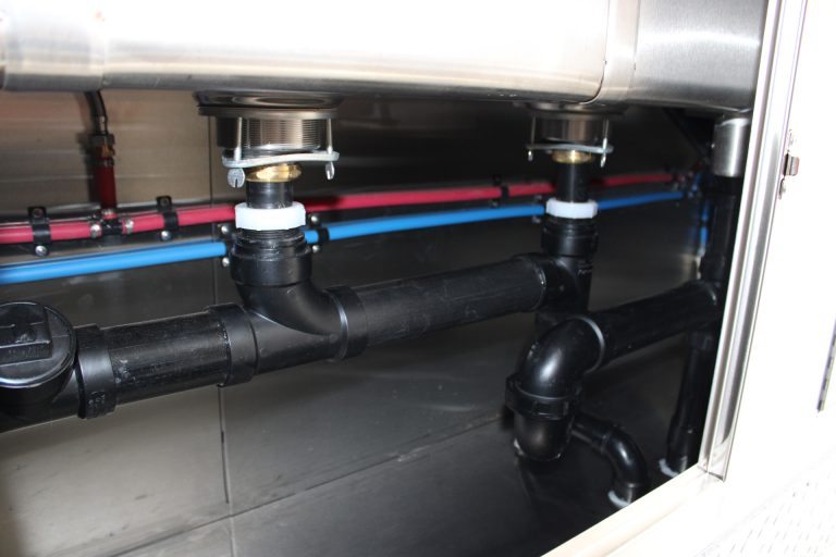 Hot and cold water plumbing lines inside the Avenal High School school food trailer
