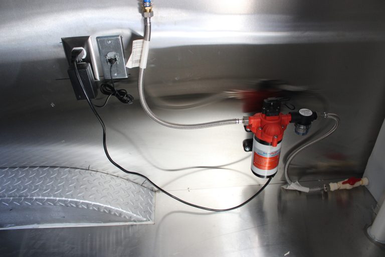 Utility equipment beneath the counter in the Avenal High School school food trailer