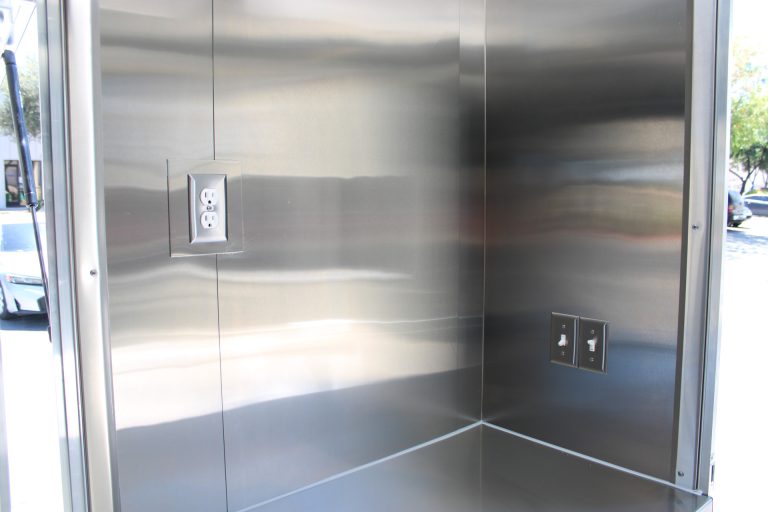 Stainless steel counter and electrical outlets inside the Avenal High School food trailer