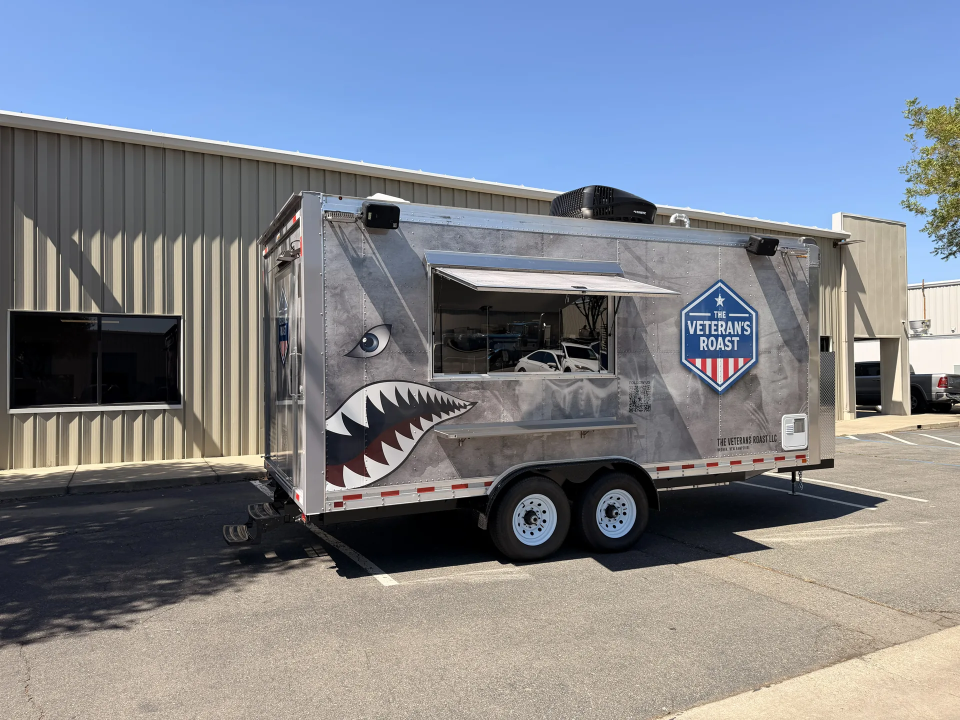 Custom food trailers with full-color wraps lined up outside the Golden State Trailers factory in Olivehurst, California, then a walk through the stainless steel commercial kitchen inside one