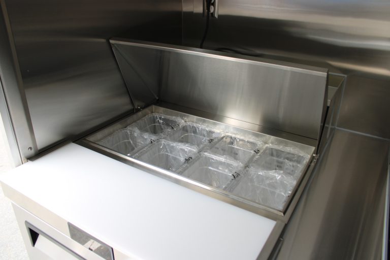 Commercial prep equipment inside a coffee food trailer.