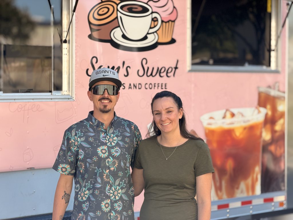 Aaron and Samantha standing in front of Sam’s Sweet Treats and Coffee custom coffee food trailer.