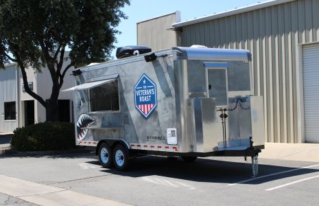 Custom-built coffee trailer exterior with branded aluminum panels and concession window