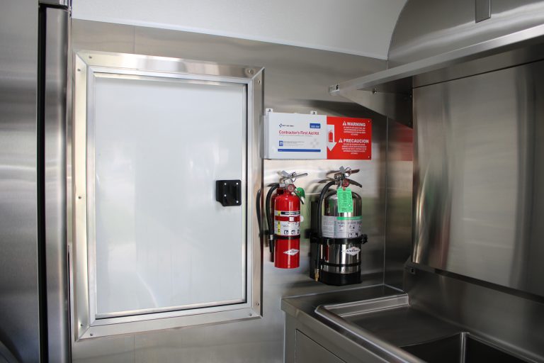 Fire extinguishers and safety equipment inside the custom 16ft coffee food trailer.