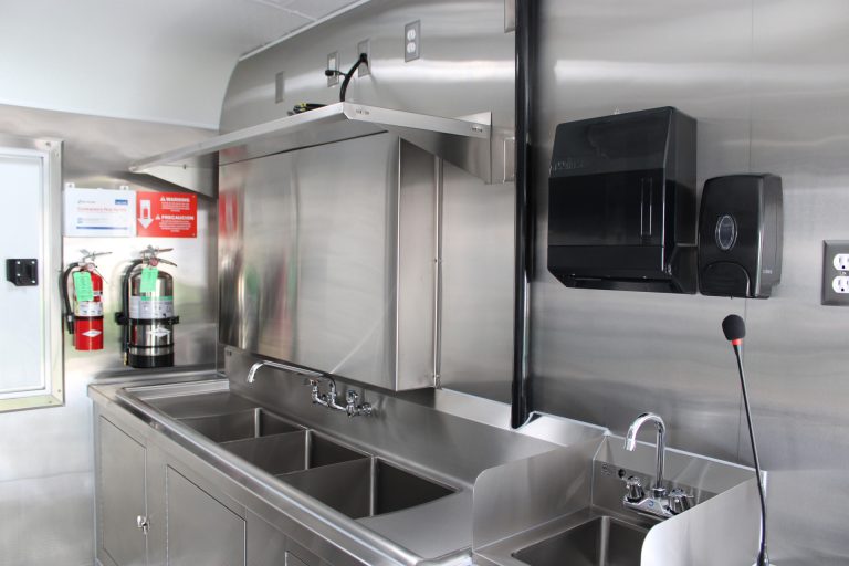 Stainless steel sink station inside the custom 16ft coffee food trailer.