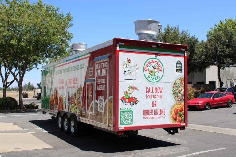 commercial pizza trailer rear-side view with custom wrap and triple-axle configuration