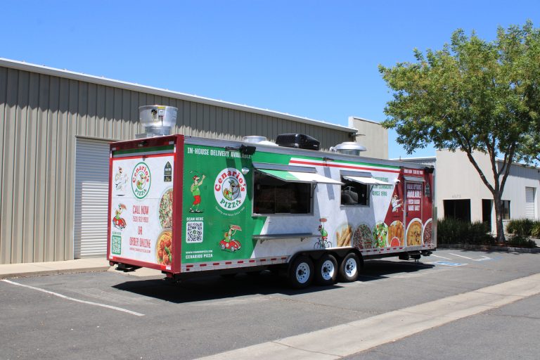 30-ft mobile pizza kitchen with custom wrap, service windows, and commercial food trailer exterior