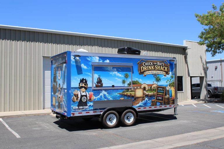 Three-quarter exterior view of the Avenal High School food trailer with service window and custom wrap