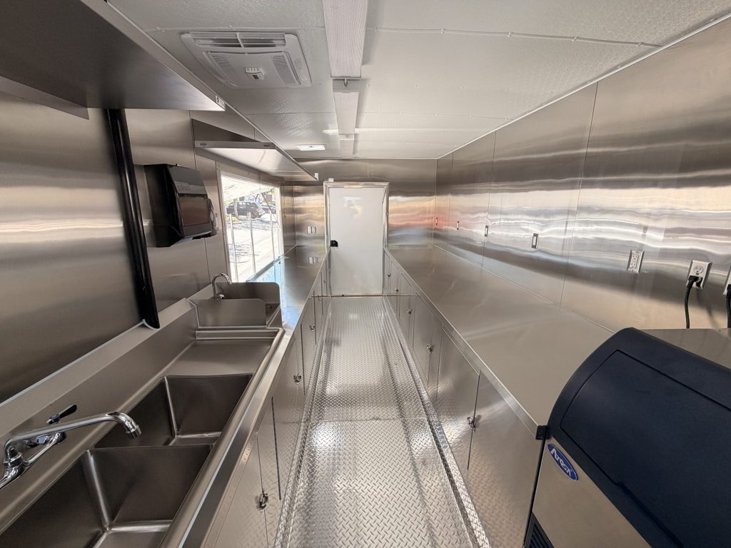 Interior of the Avenal High School school food trailer with stainless steel workstations and central aisle